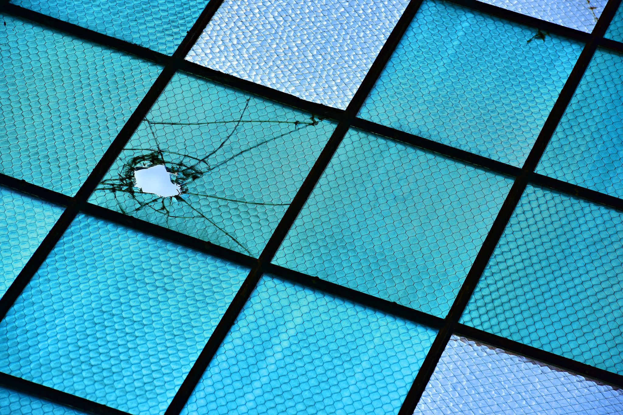 Photo of bulletholes in thte windows of Hangar 79